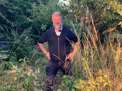 Jon among the weeds of his new plot